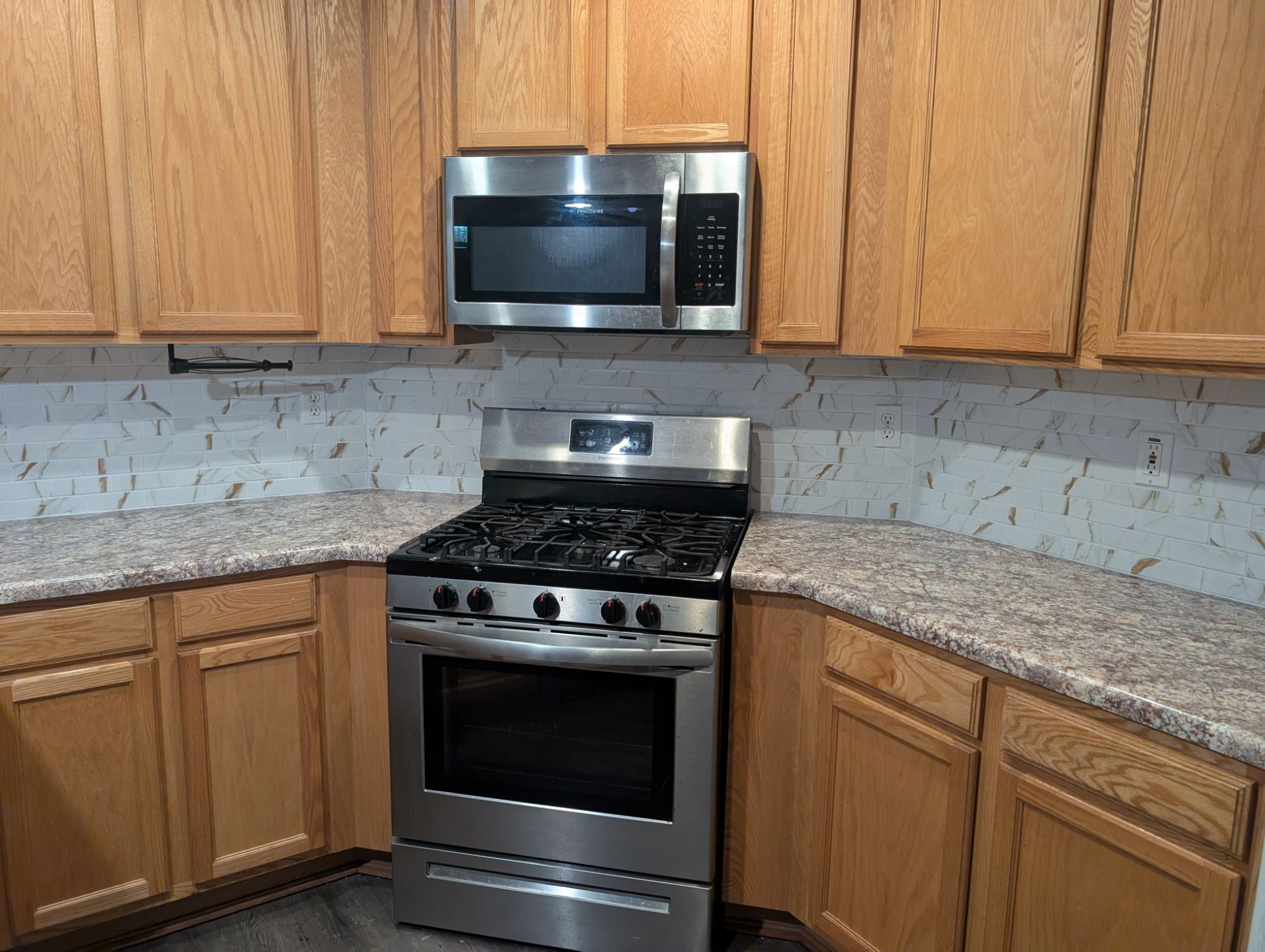 Kitchen with new countertops, new backsplash, and stainless gas range